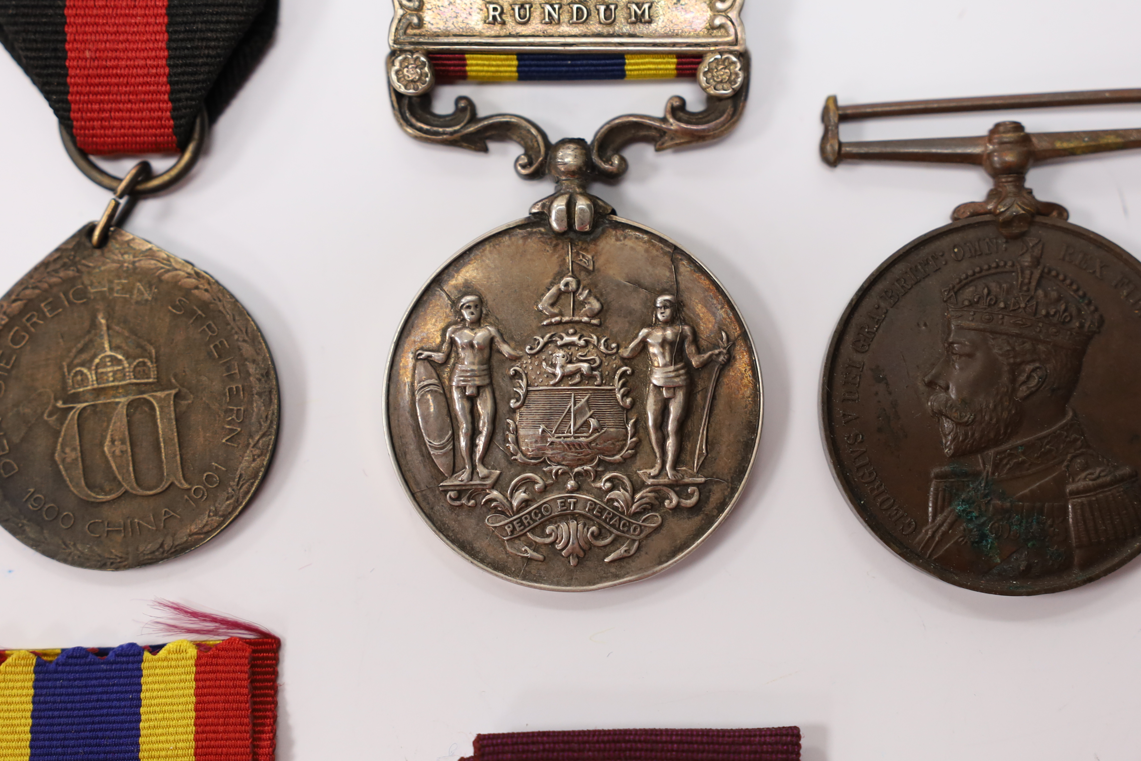 Assorted medals; two replica British North Borneo medals; Balaklava medallion; bronze GV medal; German China Campaign medal; bronze NRA medallion, unnamed